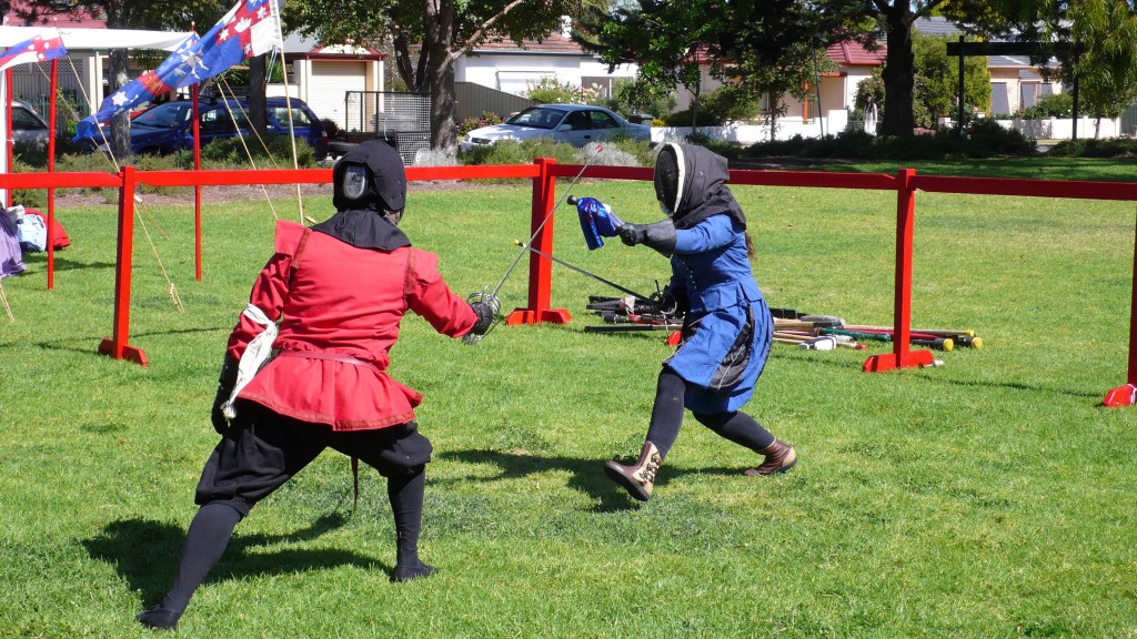 Her Majesty Angharat fencing with offhand parrying Captain Innilgard action figure. Photo by Baroness Ingerith Ryzka, April 2014
