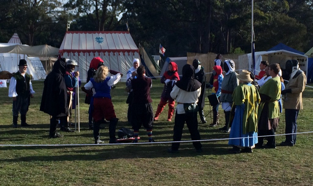 The entrants gather for instructions for the Heroes and Villains rapier tournament. Photo by THL Ceara Shionnach April 2014