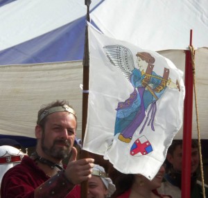 Baron Loyola holds the banner, depicting Nike the Goddess of Victory, representing the Barony of Rowany and allies win for Lochac's inaugral Olympiad. Photo by Marozia moglie di Basilio Bracciolini, April 2014