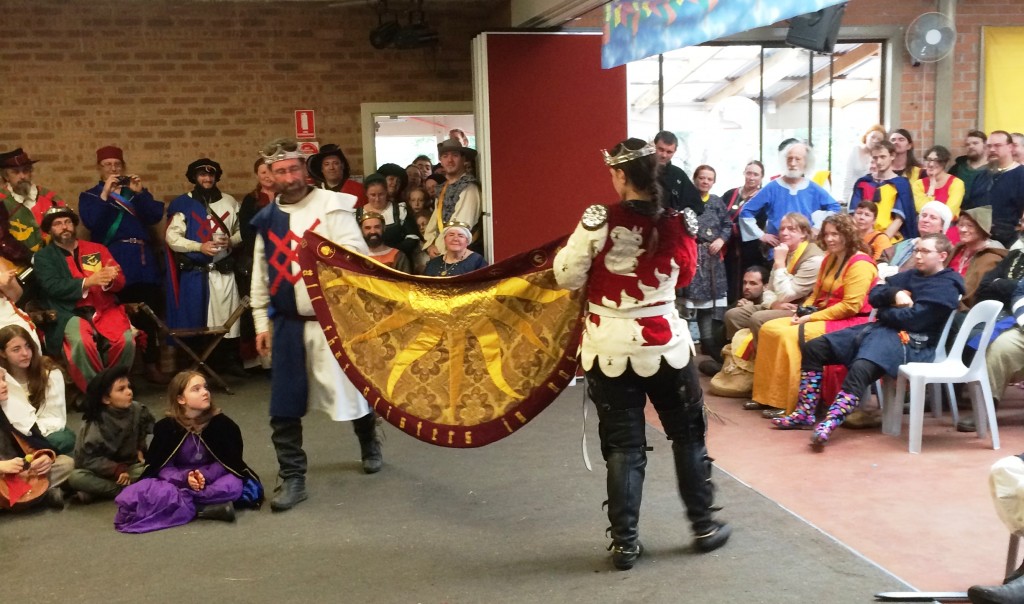 Baron Yevan de Leeds and Baroness Eva von Danzig of Innilgard present the Heroes Cloak to the Crown. Photo by THL Ceara Shionnach, April 2015.