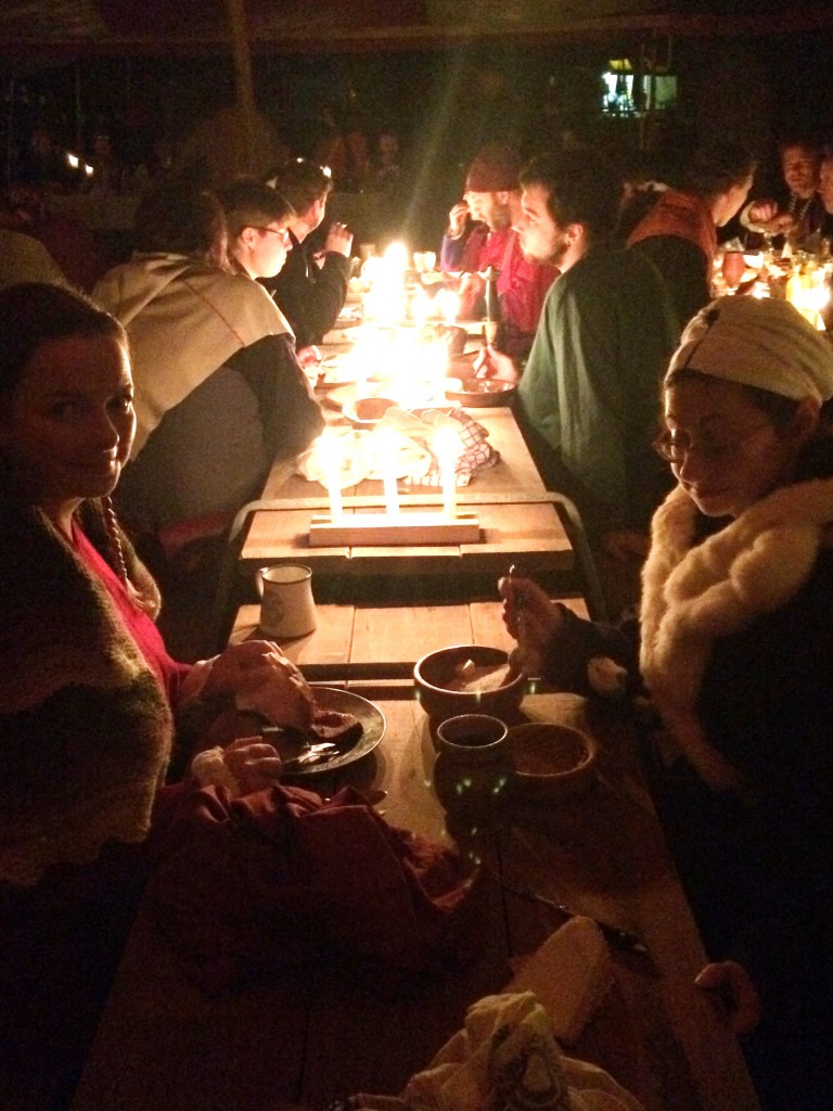 Feast goers illuminated by candle light. Photo by TH Lady Ceara Shionnach, June 2015.