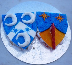 Sotelties made of Turkish delight topped by sugarplate, of Baron Aylwin Greymane and Baroness Ingerith Ryzka's heraldry. Made by Baroness Blodeuwedd y Gath. Photo by Lady Ursula Von Memmingen, April 2014