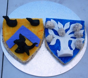 Sotelties made of Carys Brede (shortbread with caraway seeds), topped by sugarplate, of Baron Drake Morgan and Baroness Blodeuwedd y Gath's heraldry, with elements completed in leche lumbard rolled in almond meal. Made by Baroness Blodeuwedd y Gath. Photo by Lady Ursula Von Memmingen, April 2014